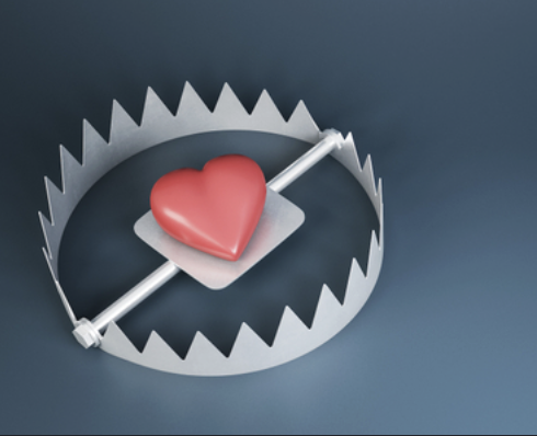 A 3D illustration of a red heart resting on the plate of a metal trap, representing romance catfishing